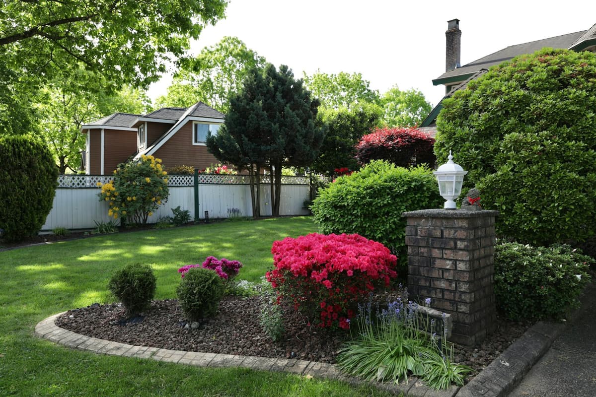 Landscaped garden bed with fresh mulch, shrubs, and flowers